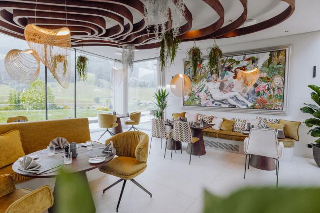 Design Restaurant mit vielen Pflanzen und Blick auf die Berge
