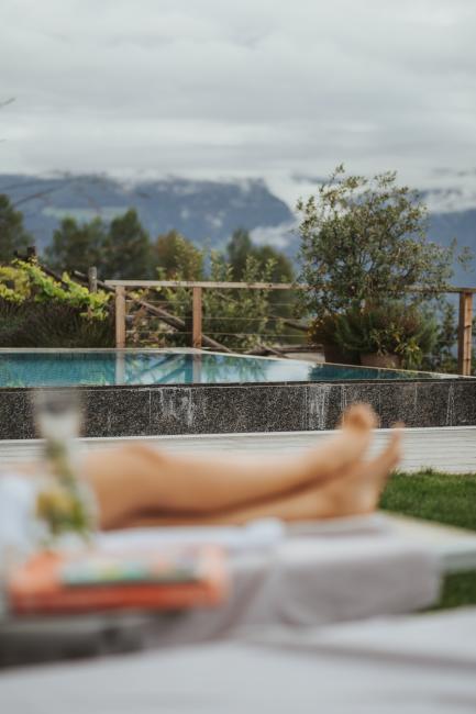 Frauenbeine am Pool in Südtirol