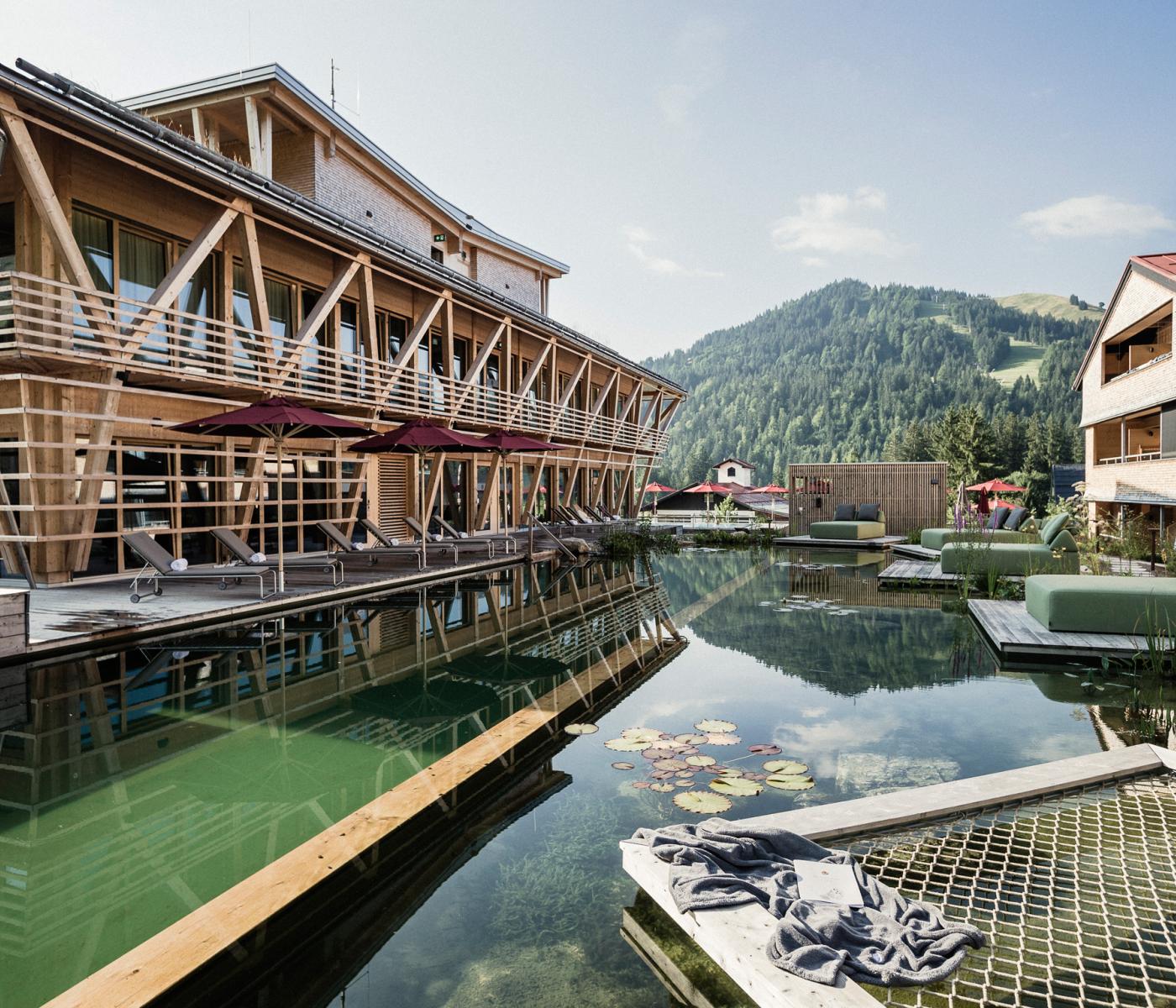 Zwei moderne Holzhäuser mit Pool dazwischen